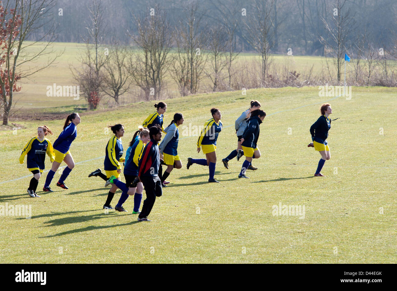 University sport, women`s footballers doing warm-up exercises before match Stock Photo